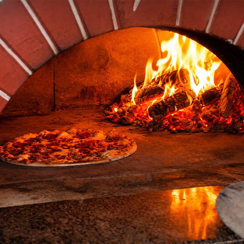 Wood-fired pizza cooked on-site at outdoor event in Connecticut