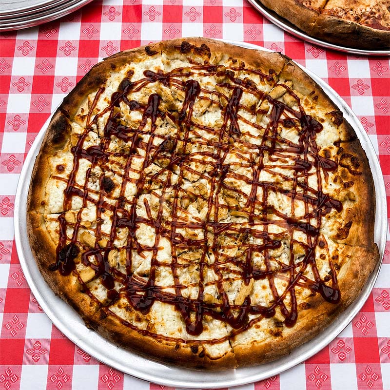 Specialty pizza from high-heat wood-fired oven at Maple Wood Pizza